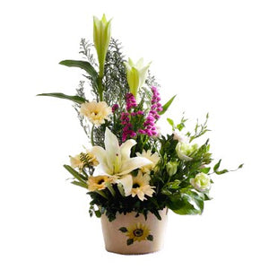White lilies, white eustoma and white gerberas table flower arrangement