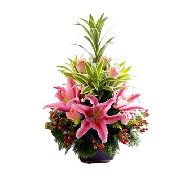 Pink lilies, pink roses and hypericum berries table flower arrangement