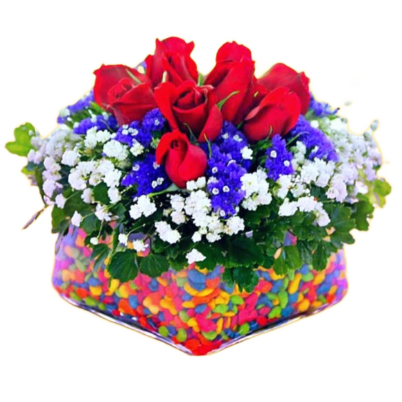 Red roses in a vase with coloured pebbles table flower arrangement