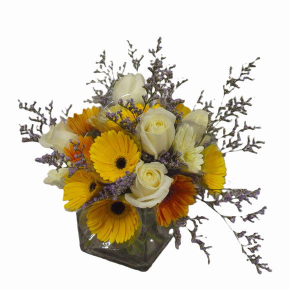White roses, mixed orange and yellow gerberas table flower arrangement