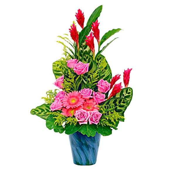 Pink gerberas, pink roses and ginger flowers in a vase table flower arrangement