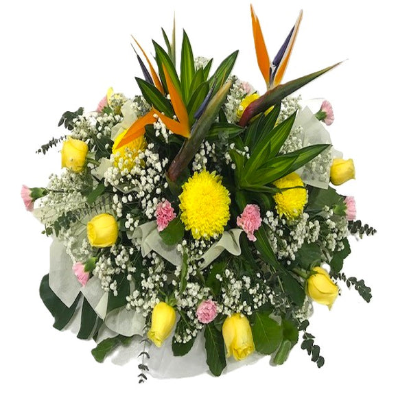 Yellow roses, pink carnations, bird of paradise and baby's breath table flower arrangement