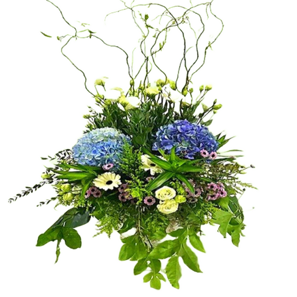 White eustoma, blue hydrangea and white gerberas table flower arrangement