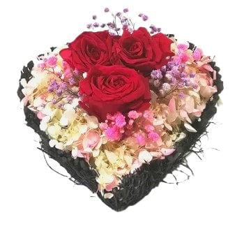 3 preserved red roses in willow basket table flower arrangement