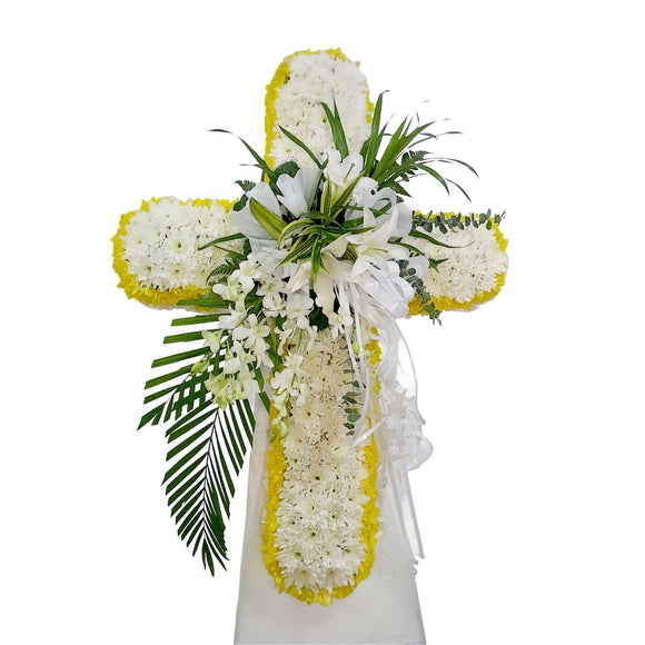 White lilies, yellow and white chrysanthemum cross wreath