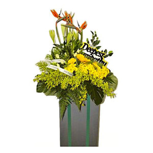 Yellow lilies, yellow gerberas, yellow roses and yellow chrysanthemum wreath