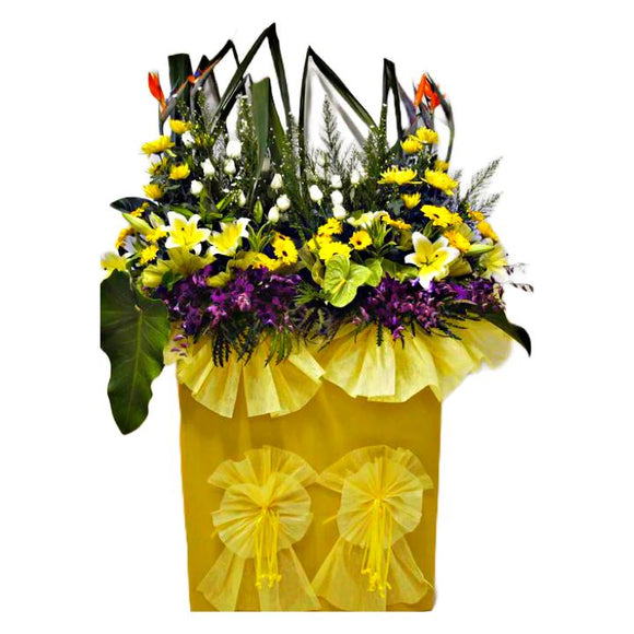 Lilies, yellow gerbera, purple orchids, white roses and yellow chrysanthemum wreath