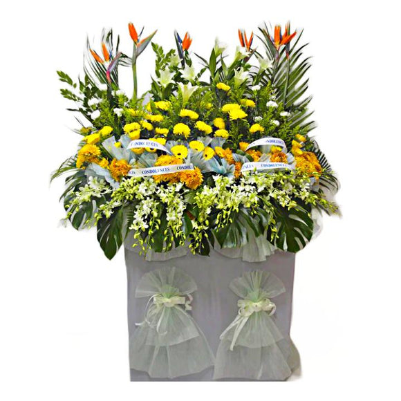 White orchids, yellow gerbera, white lilies, orange and yellow chrysanthemum wreath