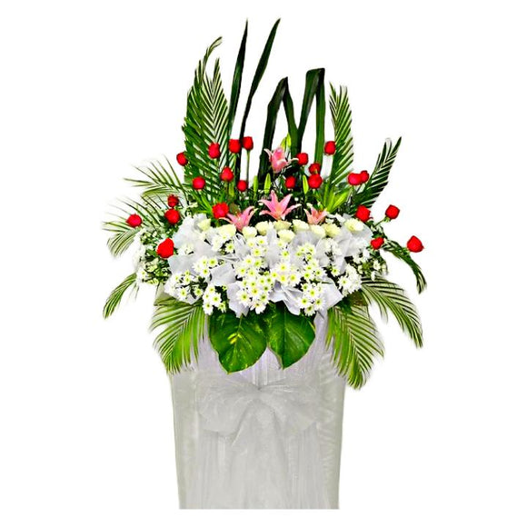 Pink lilies, red roses, white gerbera and white chrysanthemum wreath