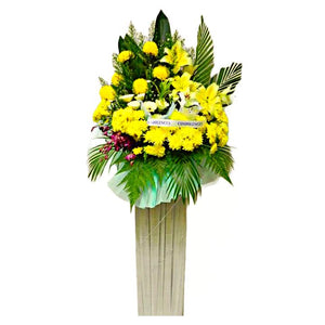 Yellow lilies, yellow gerberas and yellow chrysanthemum wreath