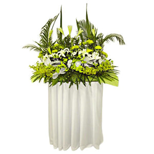 White lilies and yellow chrysanthemum wreath