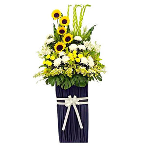 Sunflowers, yellow roses, white orchids and white chrysanthemum wreath