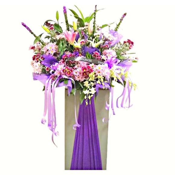 Pink lilies, pink and purple chrysanthemum wreath