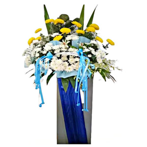 White lilies, yellow and white chrysanthemum wreath