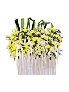 White lilies, yellow and white chrysanthemum wreath