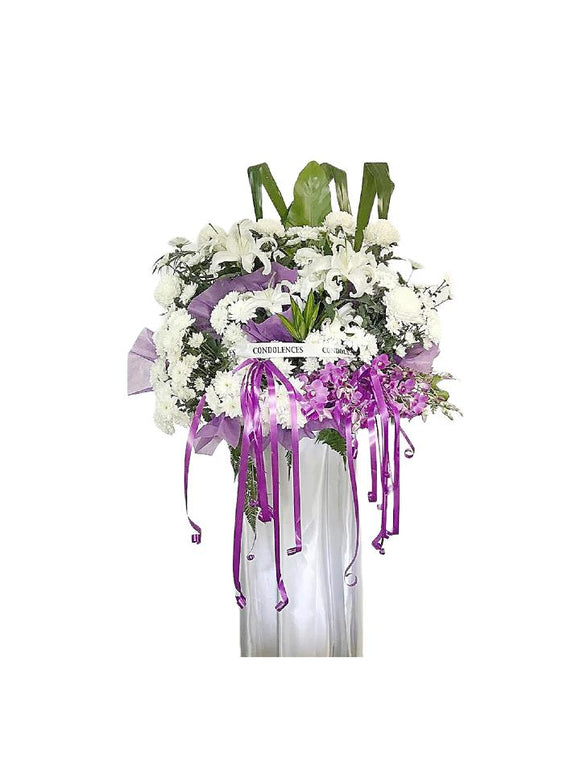 Purple orchids, white lilies and white chrysanthemum wreath