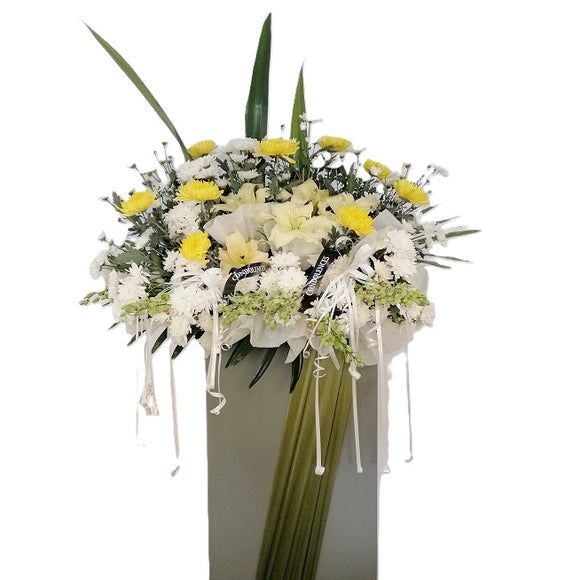 Yellow lilies, yellow and white chrysanthemum flowers wreath