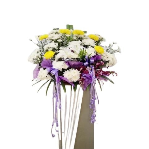 White lilies, red orchids, yellow and white chrysanthemum flowers wreath