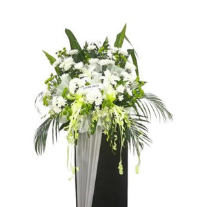 White lilies, white orchids and white chrysanthemum flowers wreath