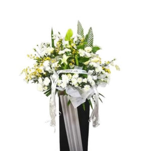 White lilies, yellow golden showers and white chrysanthemum flowers wreath