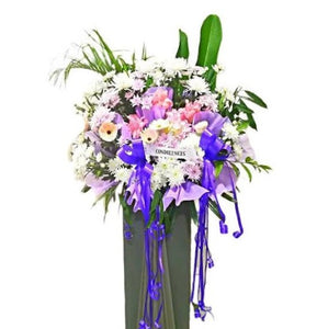 Pink ginger flowers, pink gerberas, purple and white chrysanthemum flowers wreath