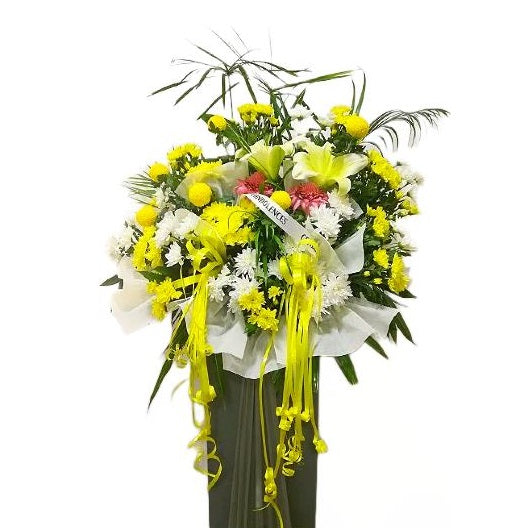 Yellow lilies, pink ginger flowers, yellow and white chrysanthemum flowers wreath