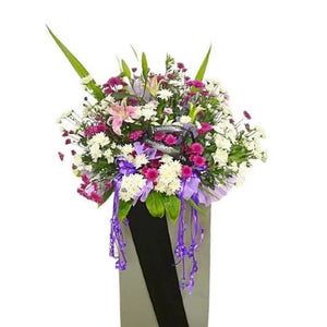 Pink lilies, purple and white chrysanthemum flowers wreath