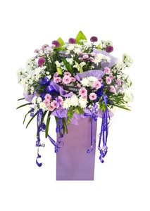 White lilies, purple and white chrysanthemum flowers wreath