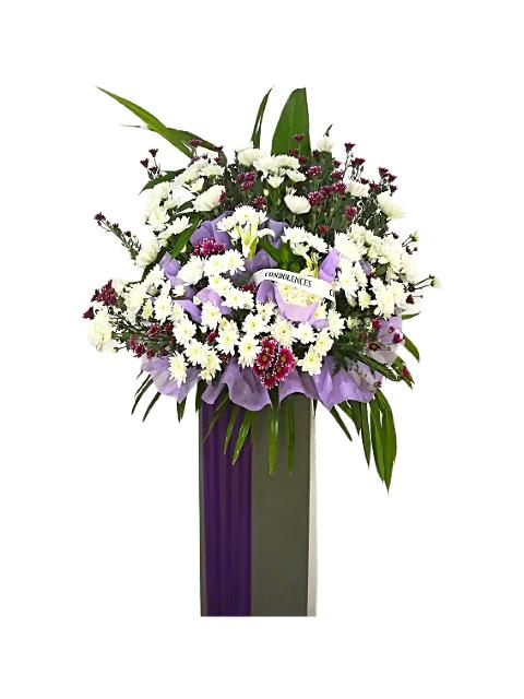 White lilies, purple and white chrysanthemum flowers wreath