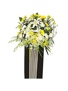 White lilies, white orchids, yellow and white chrysanthemum flowers wreath