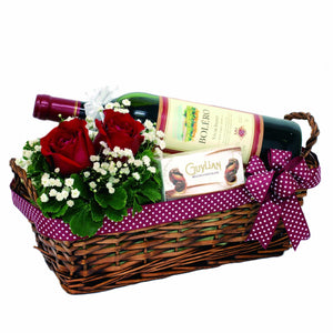 Celebratory gift hamper with red wine, chocolates and red roses bouquet