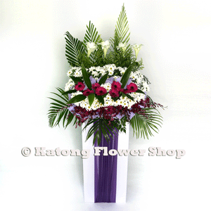 White lilies, pink gerbera and white chrysanthemum wreath