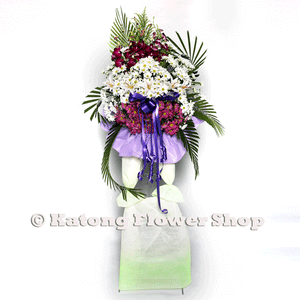 White lilies, pink and white chrysanthemum wreath