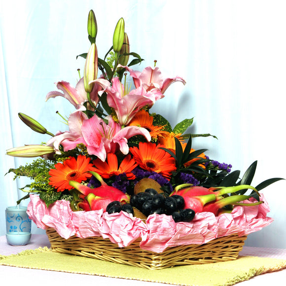 Bright and cheery fruit basket arranged with pink lilies and orange gerberas by Katong Flower Shop for singapore Delivery Options_Free Delivery