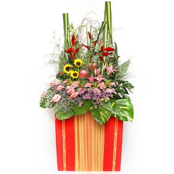 Gerbera daisies, lilies, sunflowers, heliconia and filler flowers arranged on a box stand for grand opening and congratulatory occasions by Katong Flower Shop for Singapore Delivery.