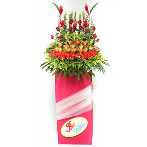Gerbera daisies, Roses and ginger flowers arranged on a box stand for grand opening and congratulatory occasions by Katong Flower Shop for Singapore Delivery.